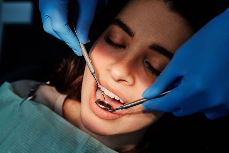 Dentist examining a patient's teeth at Care32, Kukatpally